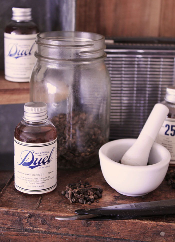 Duel ingredients — mortar and pestle, cloves, mason jar